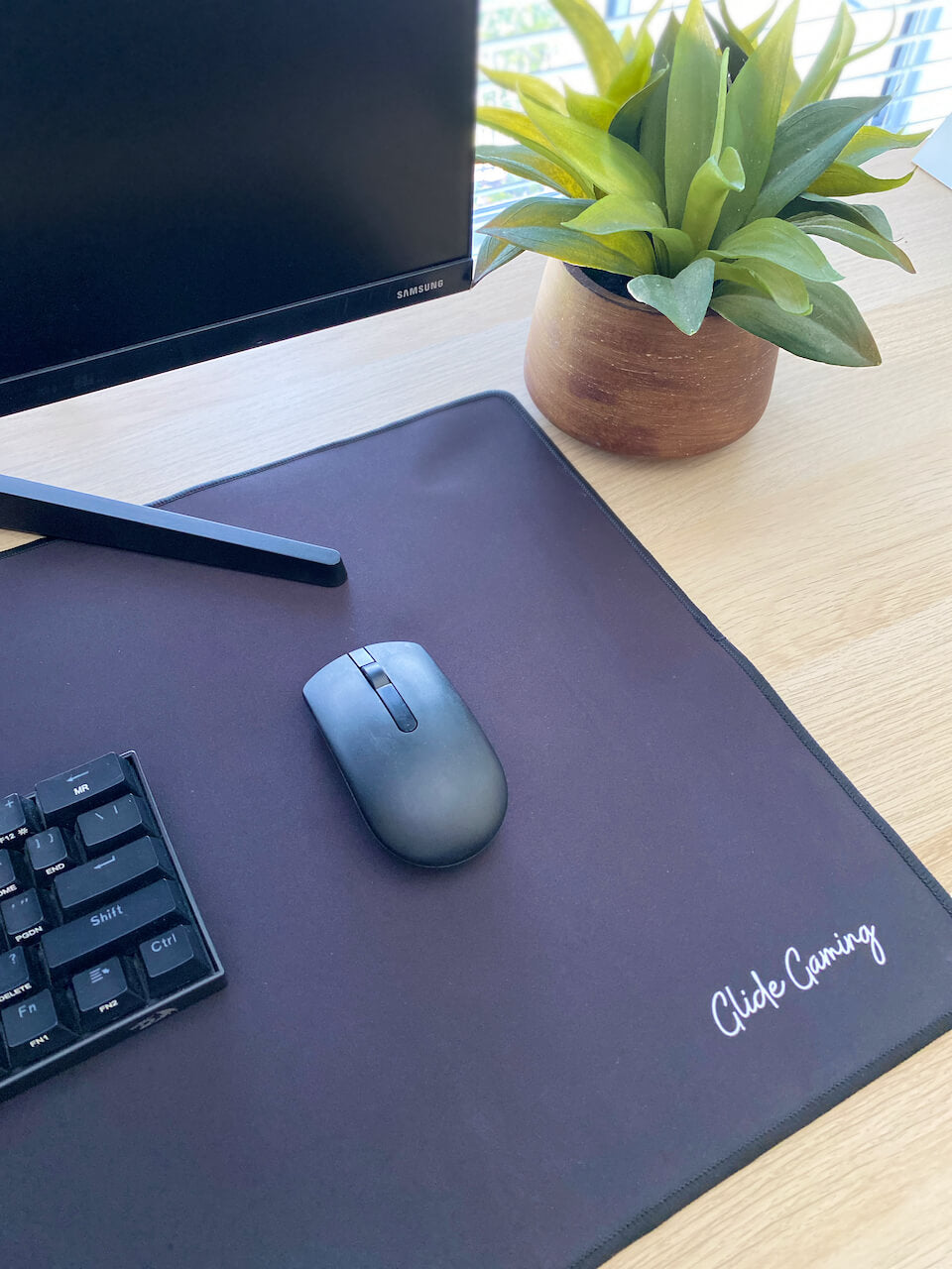 Side angle of black mousepad with Glide Gaming written on it